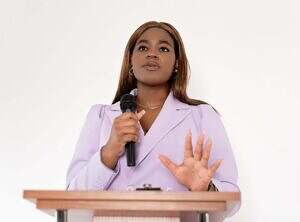 Woman delivering an inspirational talk at a podium.