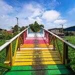 image is of a bridge painted in the colors of a rainbow