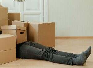man covered in a pile of boxes.