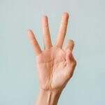 the threes in tarot. Image of a hand showing 3 fingers.