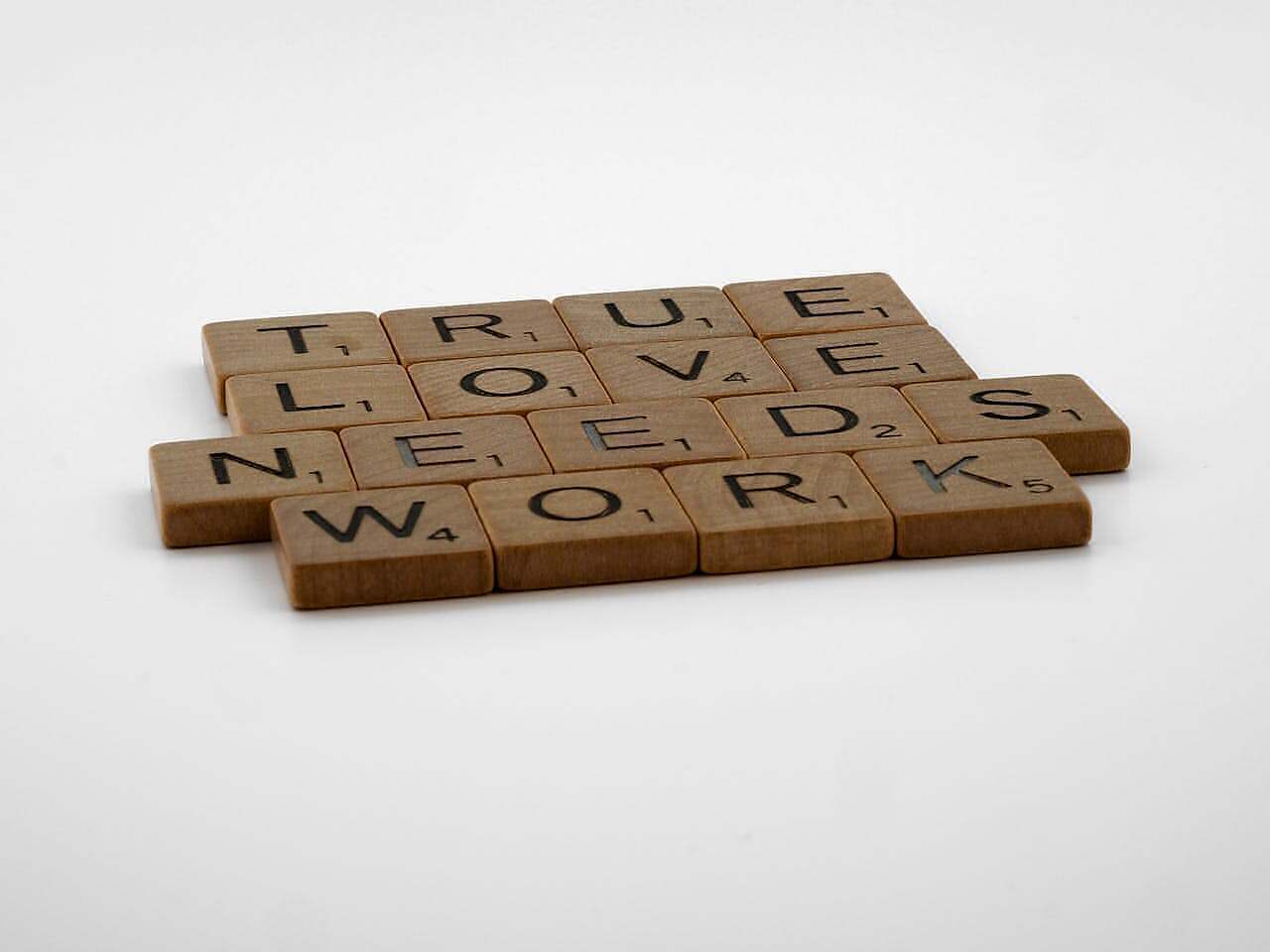 true love is different. Image of scrabble tiles spelling out true loveneeds work