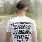 Justice and Inclusion can be done in a spiritual context. Image of a man walking on a road wearing a white t-shirt with: no Homophobia no violence no racism no sexism Yes kindness Yes Peace Yes Equality Yes love