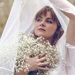 When Wisdom Becomes Your Voice Image of a woman dressed in white holding flowers.