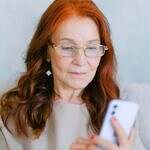 Who Can Help Me Reconnect with My Purpose? Image of a woman looking at a cell phone.