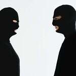The political tension of two men. Image of two masked people facing off to illustrate the political tension between Trump and Musk.