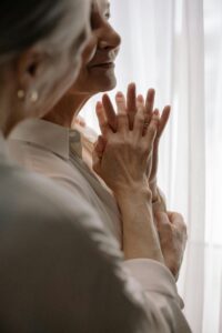Image of two women looking out a window.