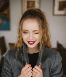 Image a woman winking confidently into the camera