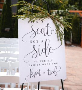 Image of a sign instructing people to pick a seat not a side...