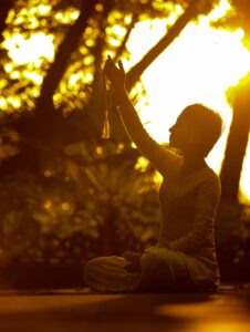 Image of a woman Spiritually Grounding her self before meditation.