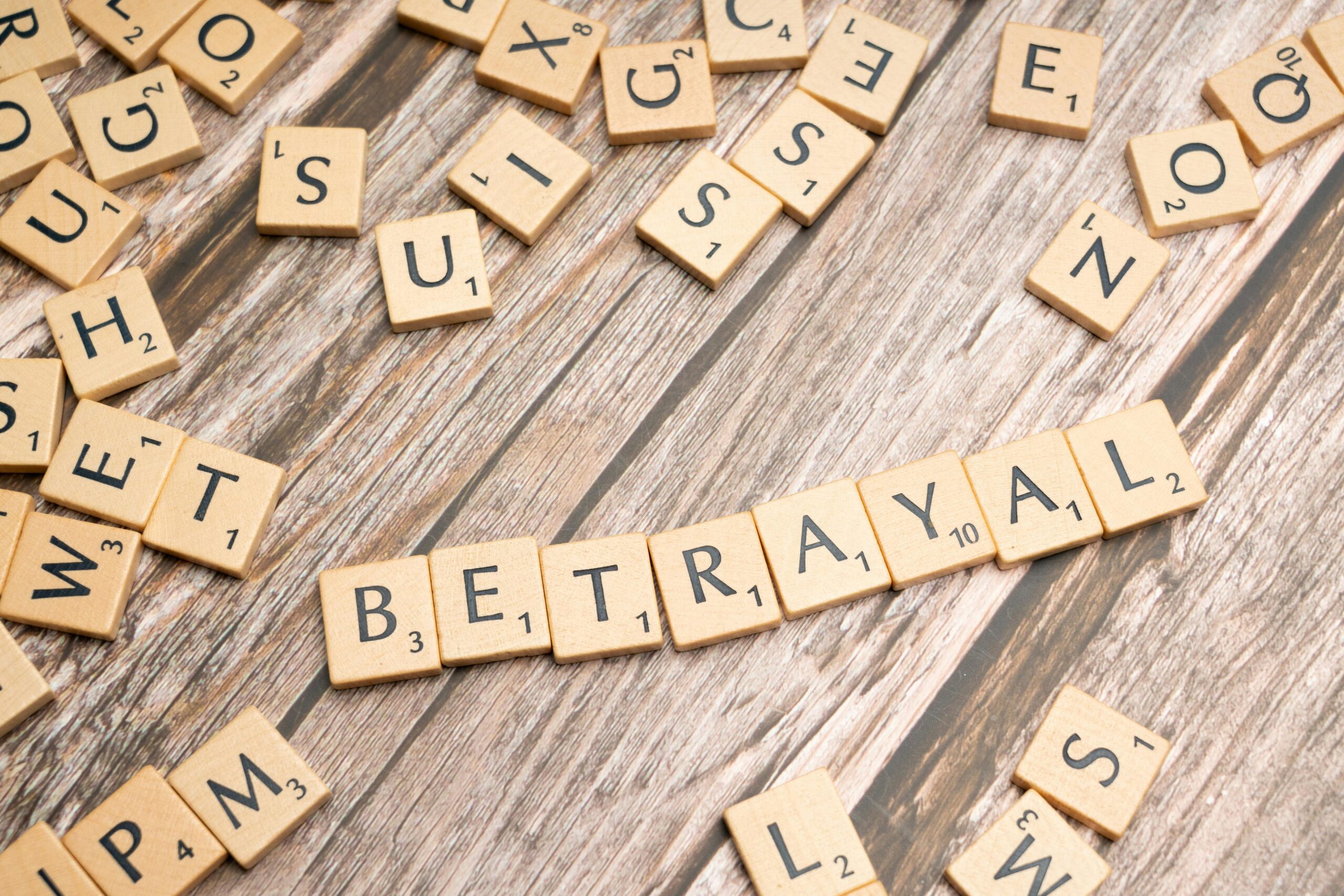 Image of scrabble tiles spelling out betrayal out.