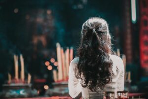 Image of a woman facing an alter.