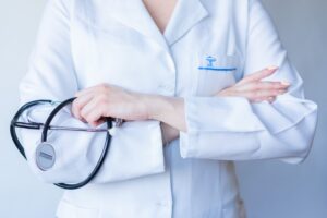 Image of a doctor with arms crossed and holding a stethoscope
