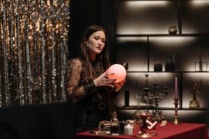 Image of a woman with metaphysical tools looking into the camera.