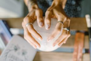 Image of a woman's hands on a crystal ball.