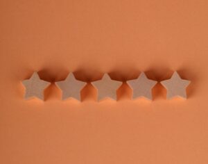 Image of 5 stars sitting on an orange background.