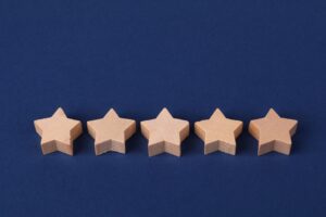 Image of 5 wooden stars on a blue background. Trust My Own Approach