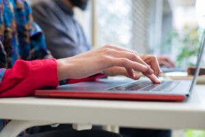 Image of a woman typing at a keyboard