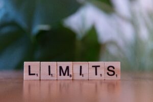 Image of Scrabble tiles spelling out the word Limits.